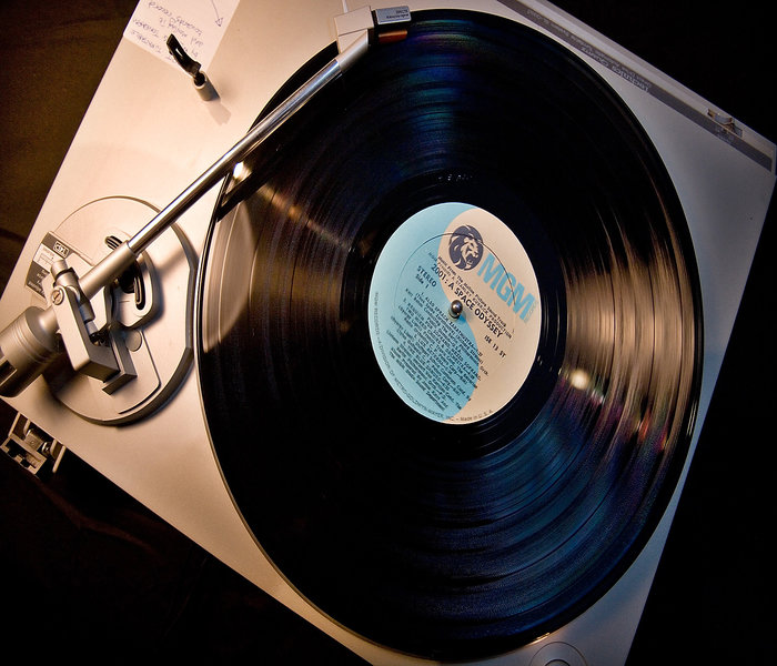 A vinyl record player and a vinyl record being played. Remember that??